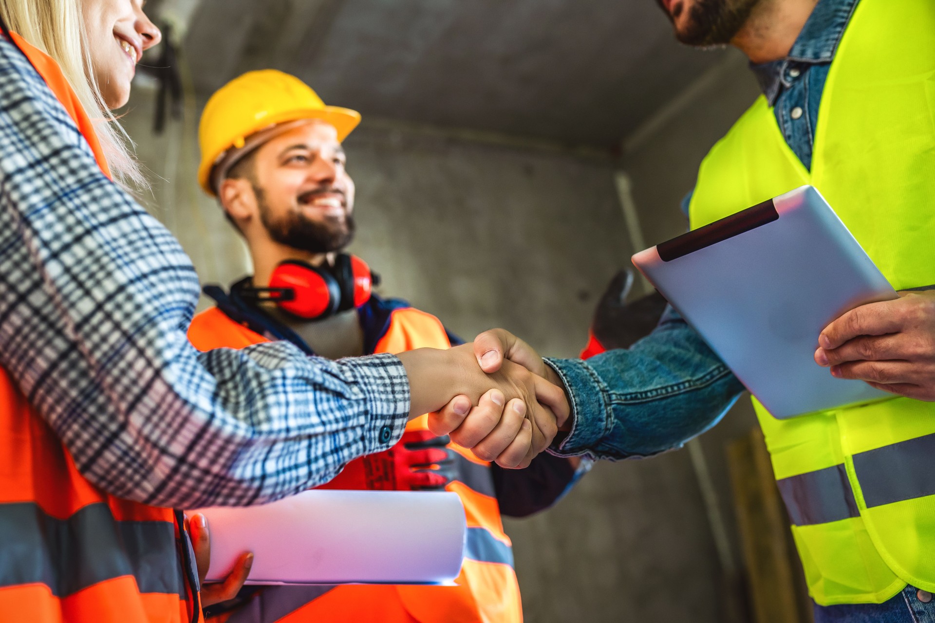 Contractor. construction worker team hands shaking after plan project contract  at construction site, contractor, engineering, partnership, construction concept